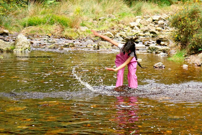 girl-pink-raingear-river-splashing
