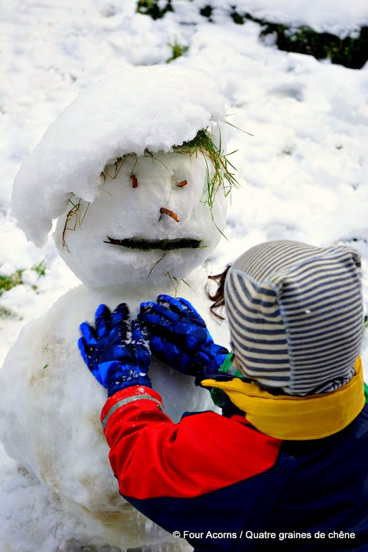 snowman-face-child-making-blue-gloves-stripy-hat