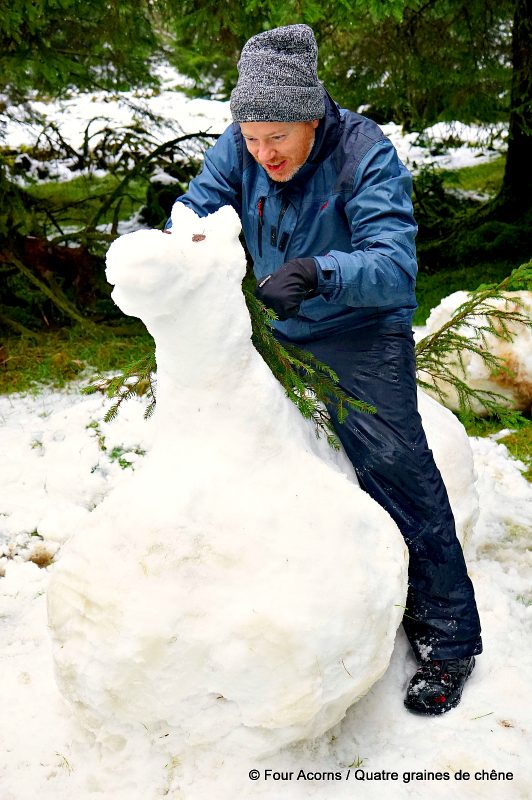 man-riding-snow-horse-sculpture