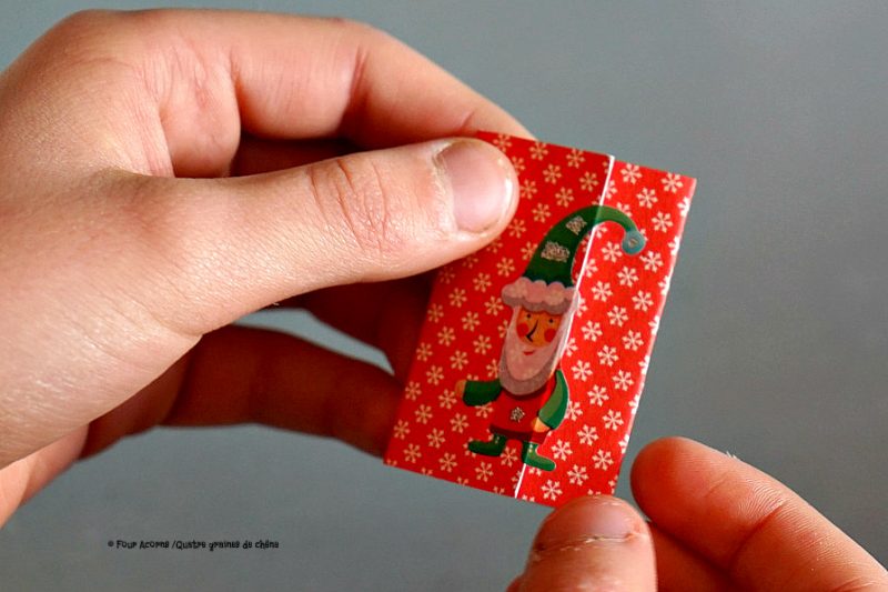 hands-holding-red-folded-note-with-elf-sticker