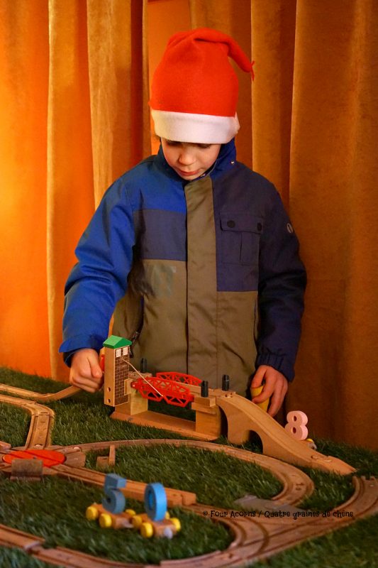 boy-santa-hat-plays-toy-trains