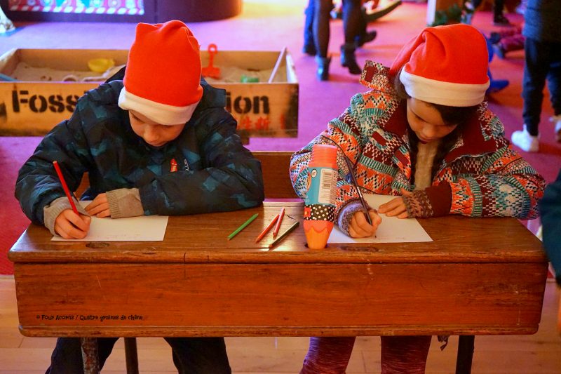 boy-girl-santa-hats-write-letters-santa-christmas