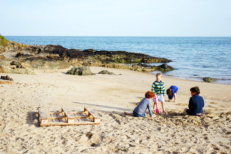 four-boys-playing-sand-beach-wicklow-ireland