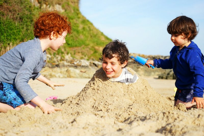 three-boys-bury-sand-sunshine-beach-wicklow-ireland