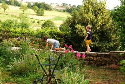 two-children-garden-wall-crawling-standing-France-summer