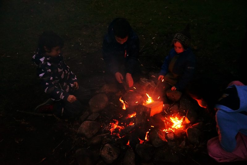 four-children-campfire-dark