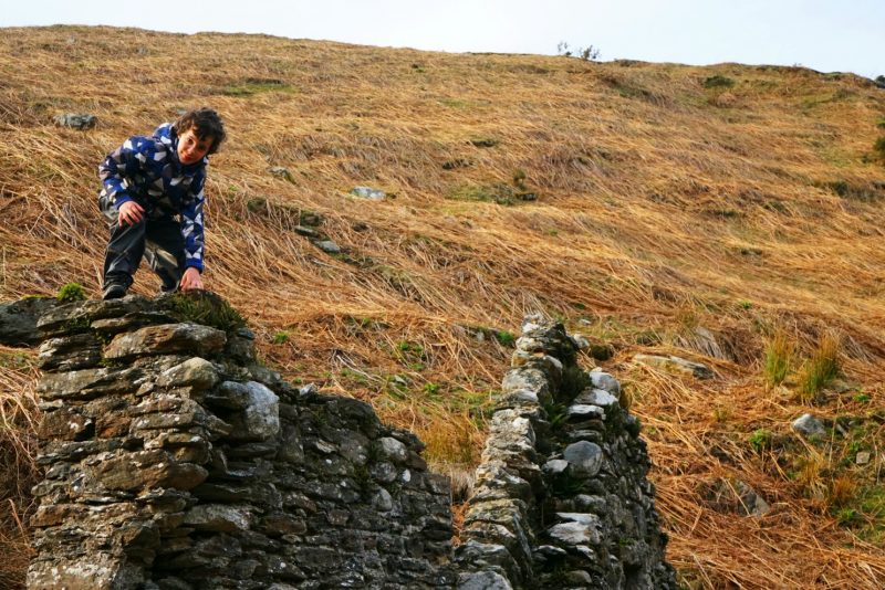 boy-climbs-house-ruins-deserted-village-wicklow-ireland