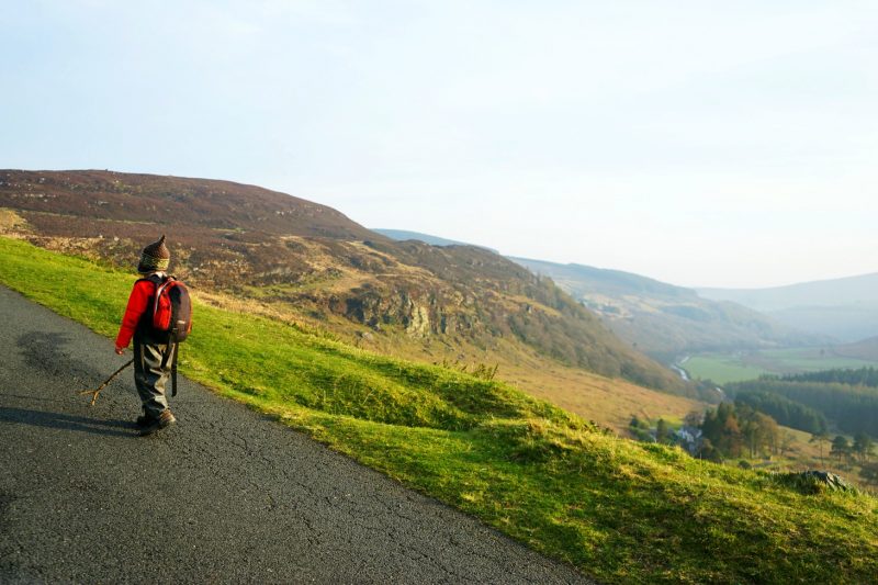 boy-hiking-road-luggala-valley-sunshine-wicklow-ireland
